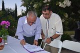 Jesus Garcia (right) and Ecuador's Jaime Benevides, sign an agreement bonding the Ecuadorian club and Lemoore's Rotary Club.